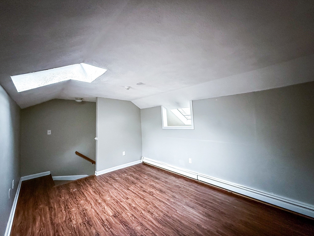 24 Wilson Street, Unit 4 Marlborough, MA 01752 - Photo 21 of 29 a view of empty room with wooden floor and fan
