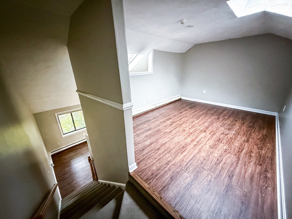 24 Wilson Street, Unit 4 Marlborough, MA 01752 - Photo 22 of 29 a view of an empty room and wooden floor and windows