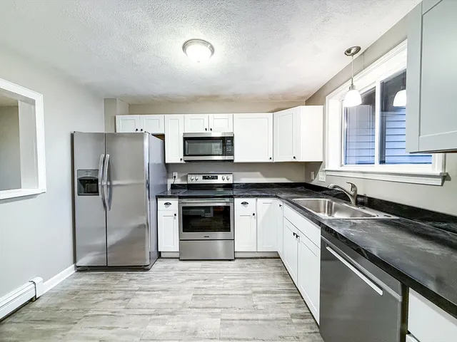 a kitchen with a sink stove and refrigerator