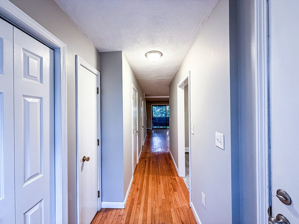24 Wilson Street, Unit 4 Marlborough, MA 01752 - Photo 7 of 29 a view of a hallway with wooden floor and closet