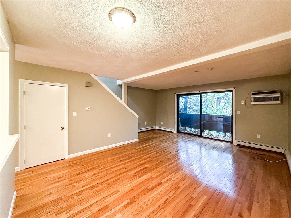 24 Wilson Street, Unit 4 Marlborough, MA 01752 - Photo 9 of 29 a view of an empty room with wooden floor and a window