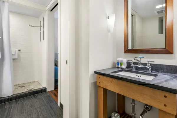 a bathroom with a granite countertop sink and a mirror