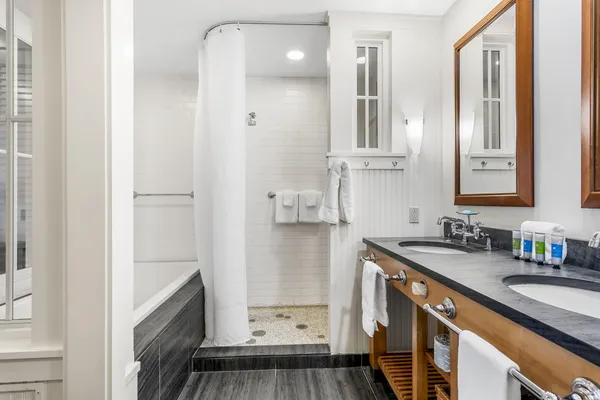 a bathroom with a sink a toilet and shower
