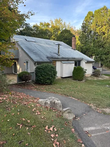 a aerial view of a house with a yard