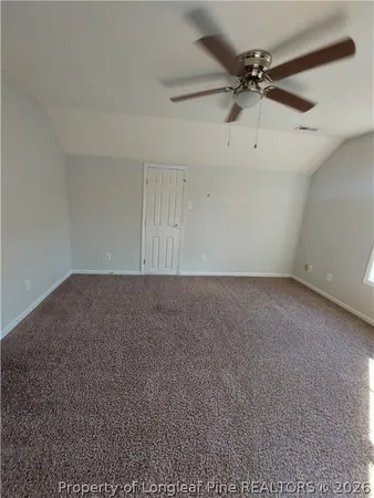 a view of a room with a ceiling fan