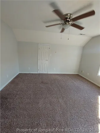 a view of a room with a ceiling fan