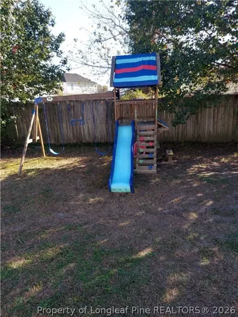 a view of a backyard with a fence