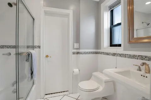 a bathroom with a toilet sink and shower