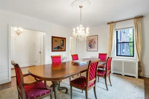 a view of a dining room with furniture and chandelier
