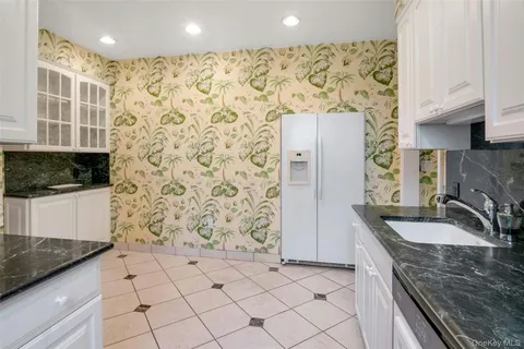 a kitchen with granite countertop a sink and a stove top oven