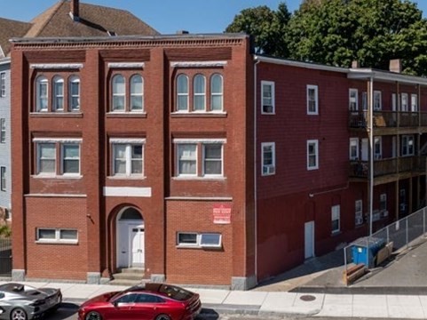 a front view of a building with parking space