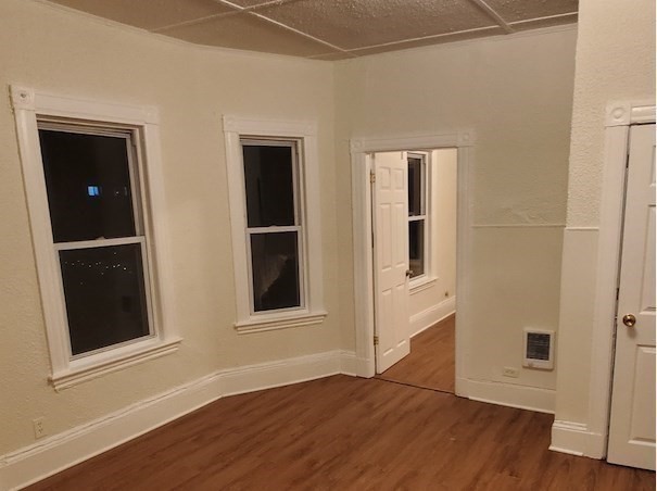176 Ferry Street, Unit 3L Everett, MA 02149 - Photo 5 of 13 a view of an empty room with wooden floor and closet