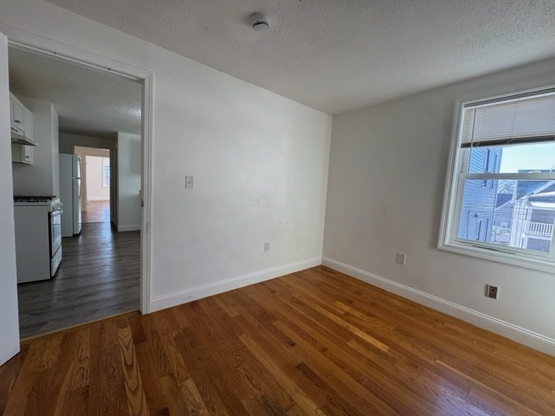 176 Ferry Street, Unit 3L Everett, MA 02149 - Photo 7 of 13 wooden floor in an empty room