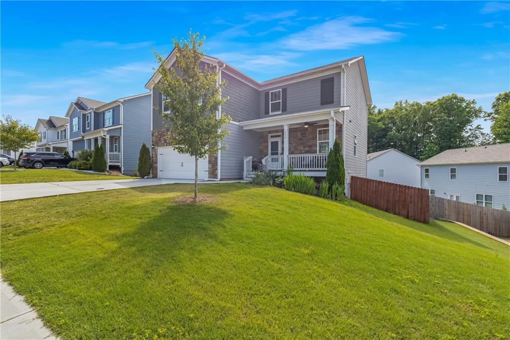 575 Walnut Grv Way Pendergrass, GA 30567 - Photo 4 of 39 a view of a house with a yard