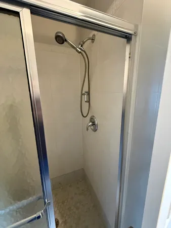 a bathroom with a glass shower door