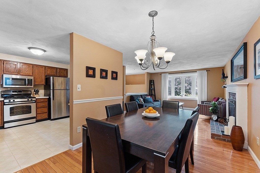 3 Neel Road Worcester, MA 01605 - Photo 15 of 41 a view of a dining room with furniture a chandelier and wooden floor