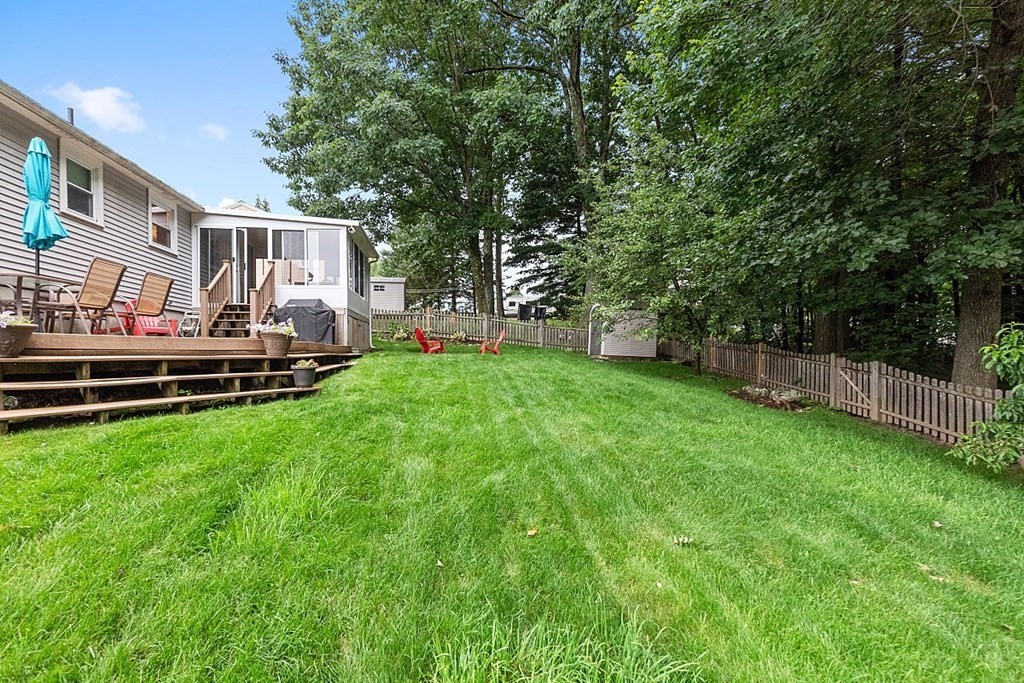 3 Neel Road Worcester, MA 01605 - Photo 3 of 41 a view of a backyard with table and chairs and wooden fence