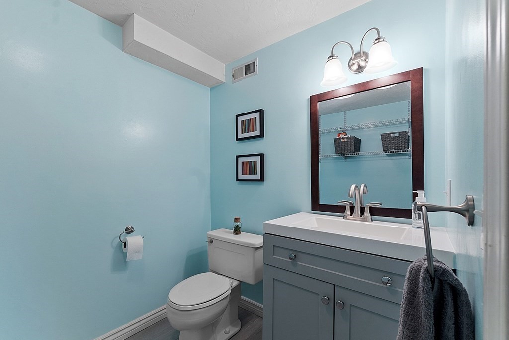 3 Neel Road Worcester, MA 01605 - Photo 32 of 41 a bathroom with a toilet a sink and mirror