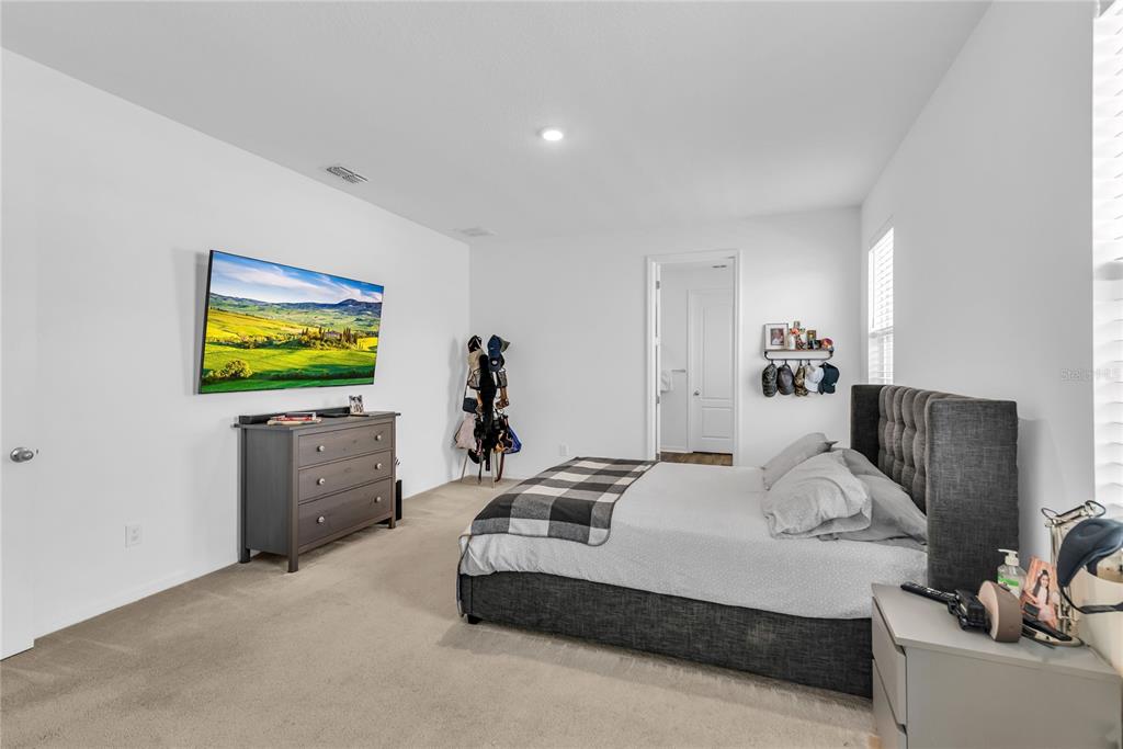 5816 Bar Ranch Road St. Cloud, FL 34771 - Photo 12 of 43 a bedroom with a bed and flat screen tv