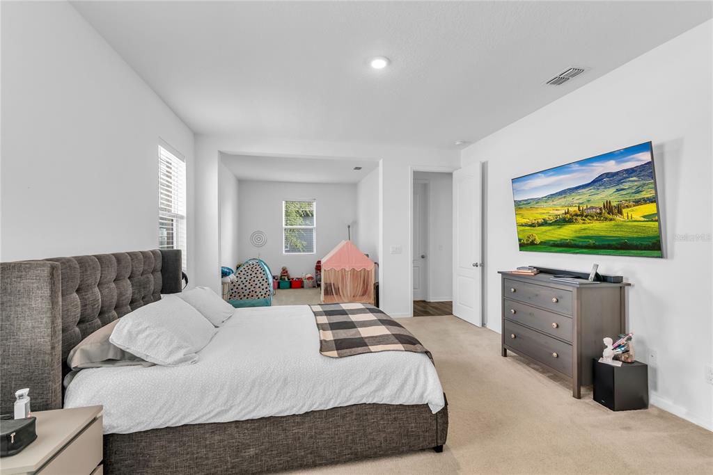 5816 Bar Ranch Road St. Cloud, FL 34771 - Photo 13 of 43 a bedroom with a bed and a flat screen tv