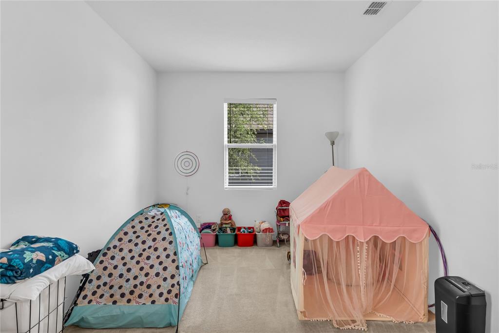 5816 Bar Ranch Road St. Cloud, FL 34771 - Photo 14 of 43 a bedroom with a bed and a window