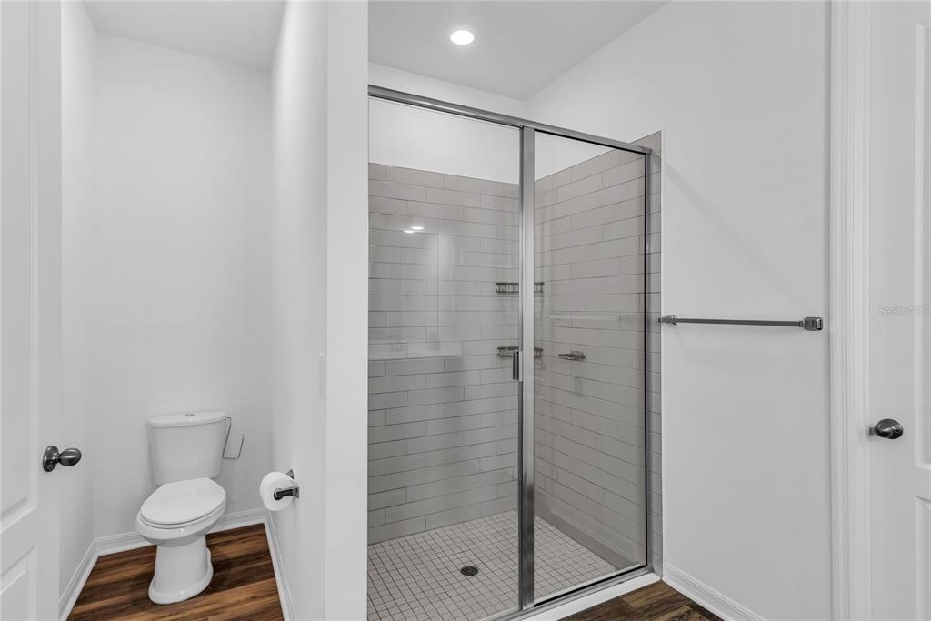 5816 Bar Ranch Road St. Cloud, FL 34771 - Photo 17 of 43 a bathroom with a shower a toilet and a sink