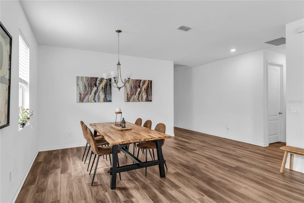 5816 Bar Ranch Road St. Cloud, FL 34771 - Photo 26 of 43 a view of a dining room with furniture window and wooden floor