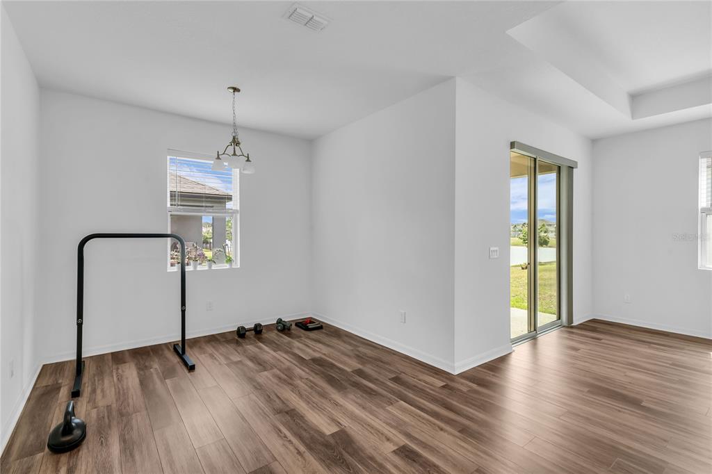5816 Bar Ranch Road St. Cloud, FL 34771 - Photo 28 of 43 a view of empty room with wooden floor and fan