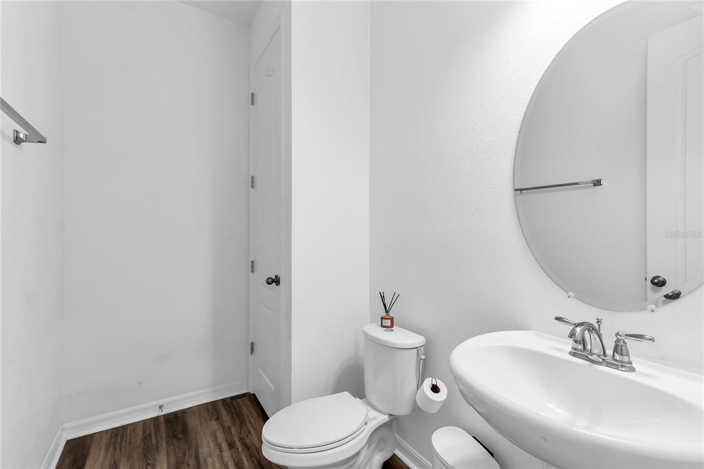5816 Bar Ranch Road St. Cloud, FL 34771 - Photo 30 of 43 a white toilet sitting next to a bathroom sink