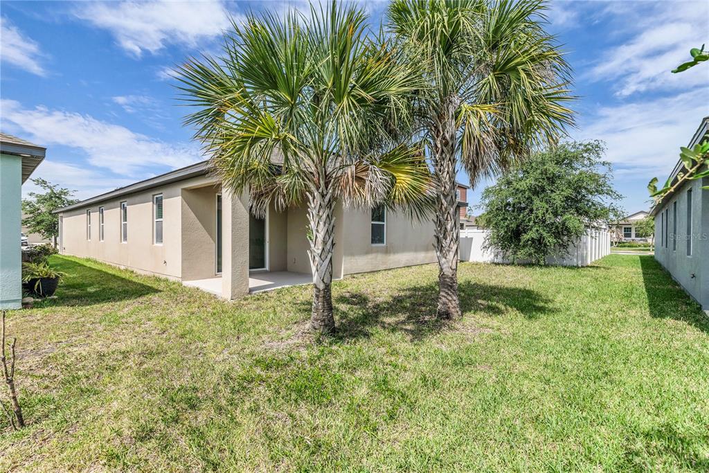5816 Bar Ranch Road St. Cloud, FL 34771 - Photo 35 of 43 a backyard of a house with plants and outdoor seating