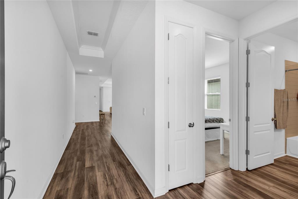 5816 Bar Ranch Road St. Cloud, FL 34771 - Photo 4 of 43 a view of a hallway with wooden floor and staircase
