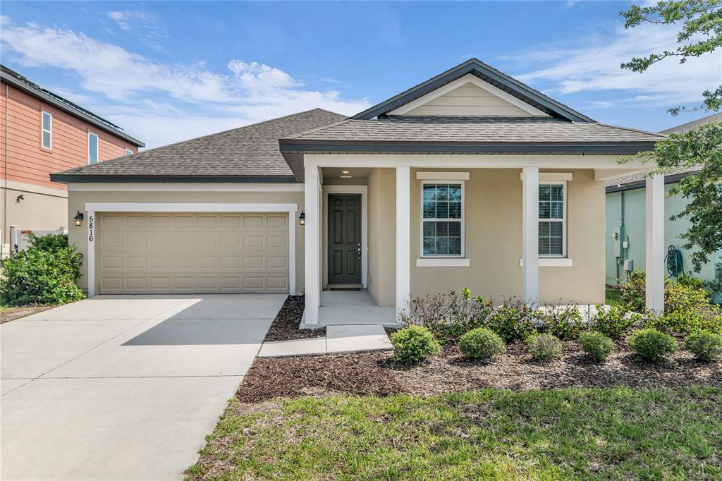 5816 Bar Ranch Road St. Cloud, FL 34771 - Photo 42 of 43 a front view of a house with a garden