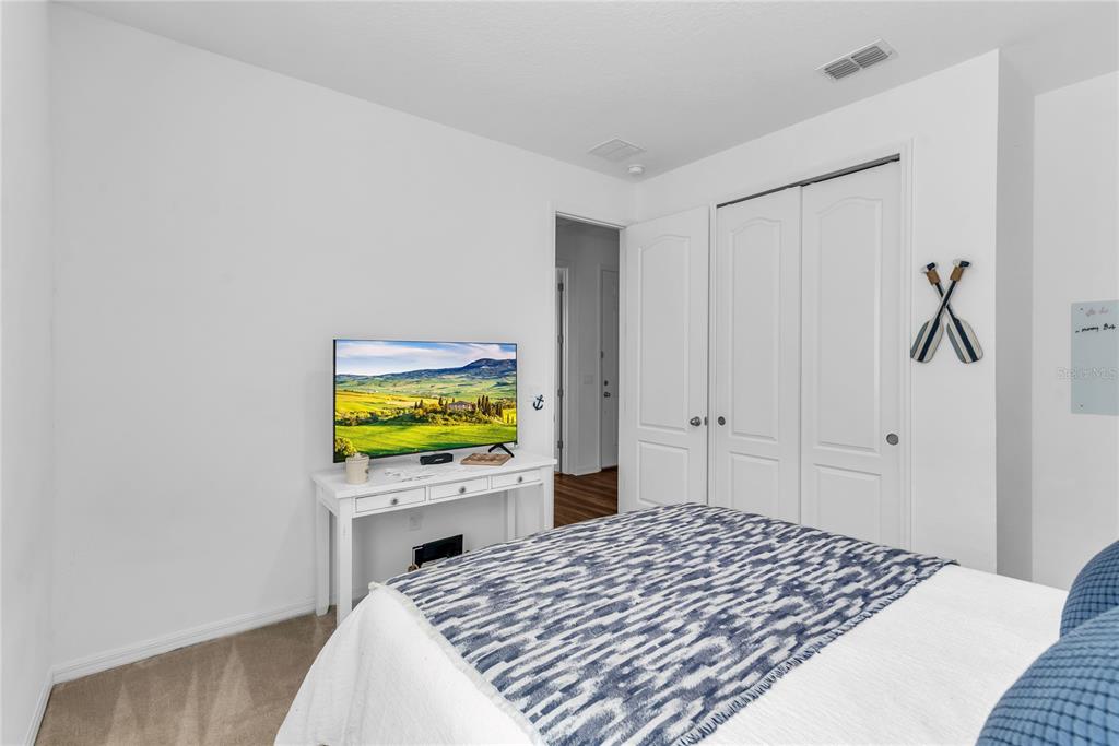 5816 Bar Ranch Road St. Cloud, FL 34771 - Photo 10 of 43 a bedroom with a bed and a flat screen tv