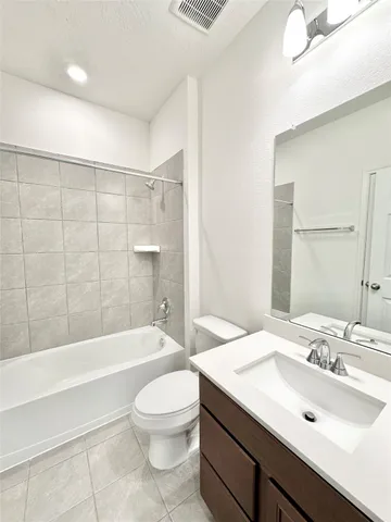 a bathroom with a sink a toilet and bathtub