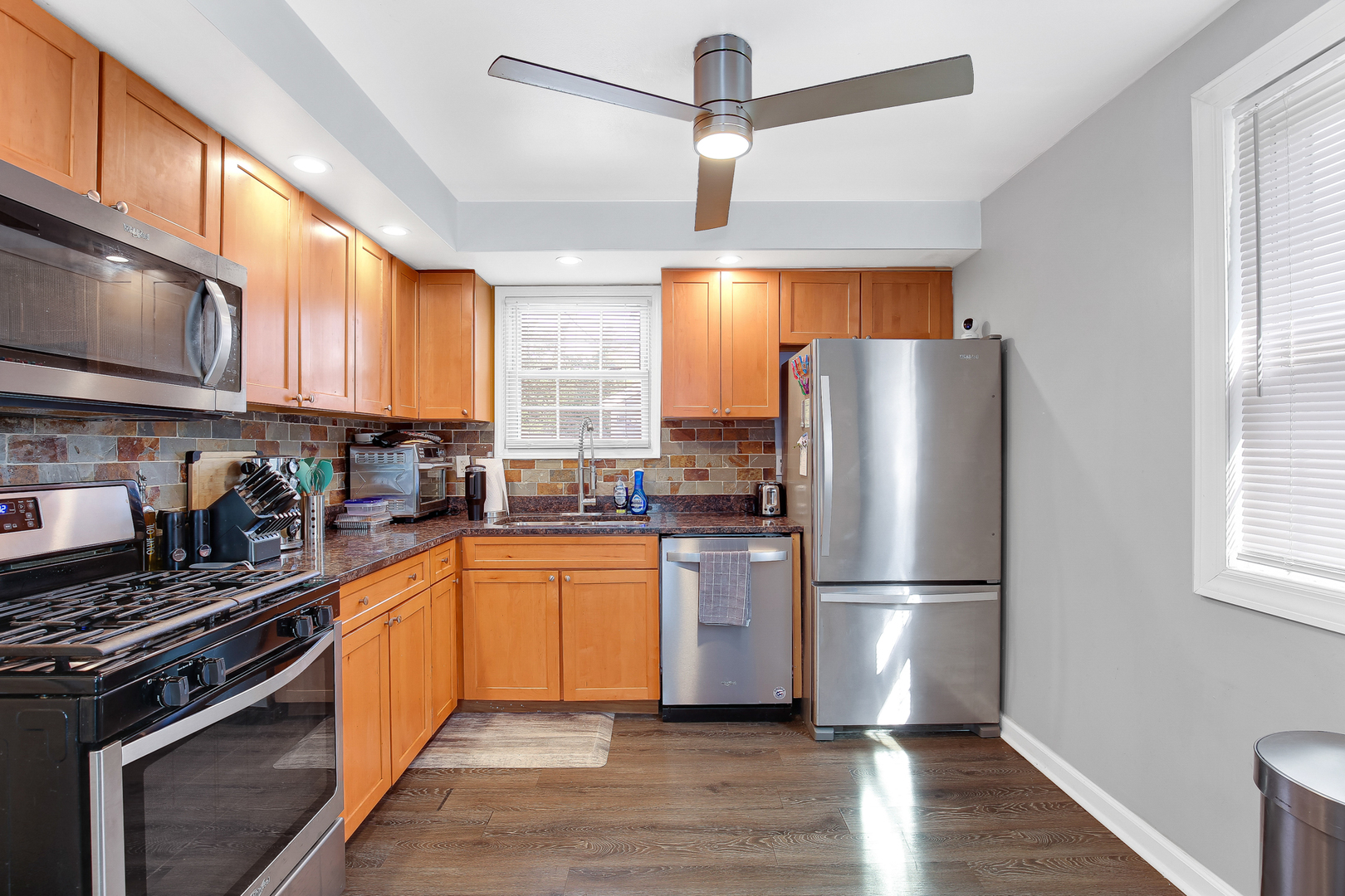 38 Monee Road Park Forest, IL 60466 - Photo 7 of 19 a kitchen with stainless steel appliances granite countertop a refrigerator a stove a sink and a window