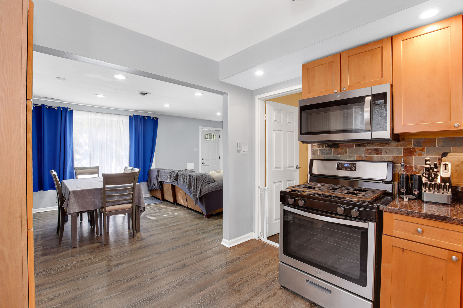 38 Monee Road Park Forest, IL 60466 - Photo 9 of 19 a kitchen with stainless steel appliances a stove a sink a microwave and wooden cabinets