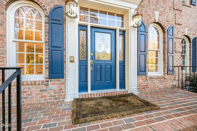 a living room with patio furniture and a large window