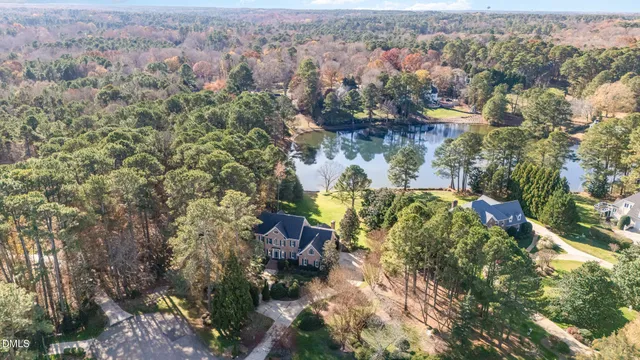 a view of an empty room with wooden floor and a fireplace