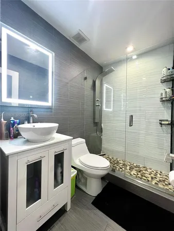a bathroom with a sink toilet and shower