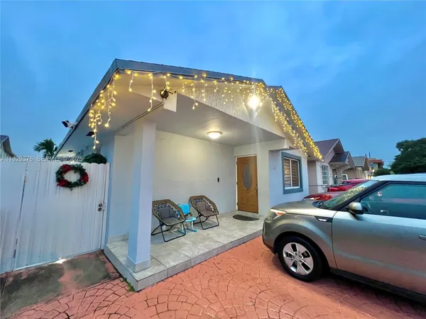 a front view of a house with parking space