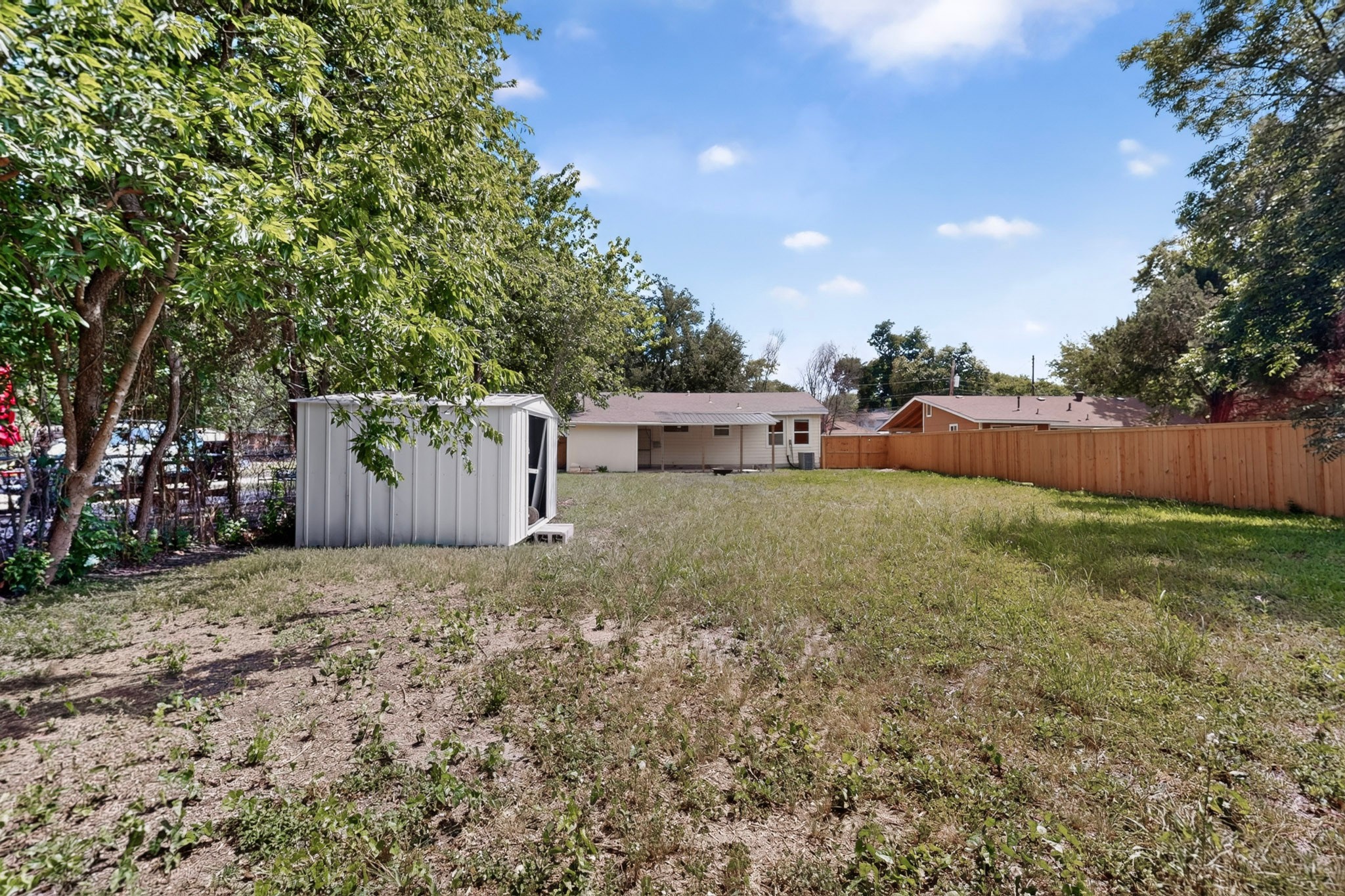 4711 Alf Avenue Austin, TX 78721 - Photo 32 of 34 A spacious backyard with mature trees and storage shed