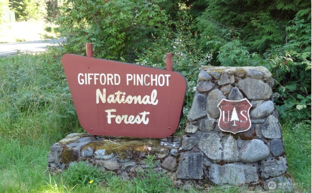 56207 Kernahan Road East Ashford, WA 98304 - Photo 5 of 9 a sign that is sitting on a brick wall