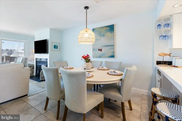 a view of a patio with table and chairs a barbeque with wooden floor