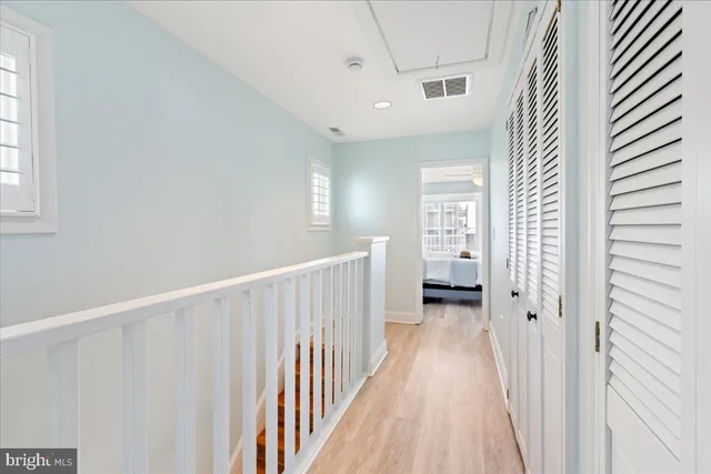 a front view of a multi story residential apartment building with yard and sign board