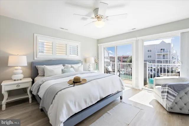 an aerial view of ocean and residential houses with outdoor space