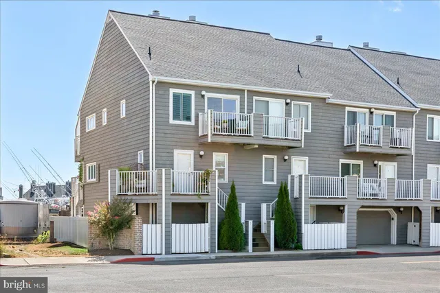 a front view of a residential apartment building with a yard
