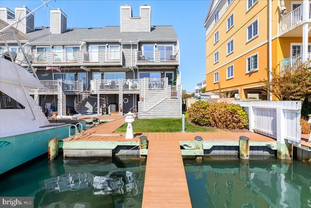 a bathroom with a sink a mirror and a potted plant
