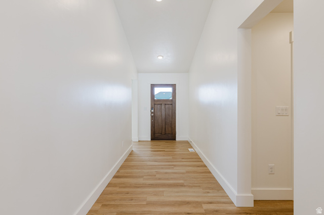 433 North 600 West Smithfield, UT 84335 - Photo 9 of 40 Entryway featuring wood-finish flooring, recessed lighting, white trim, a dark wood-paneled door with an integrated window, and a light-colored interior