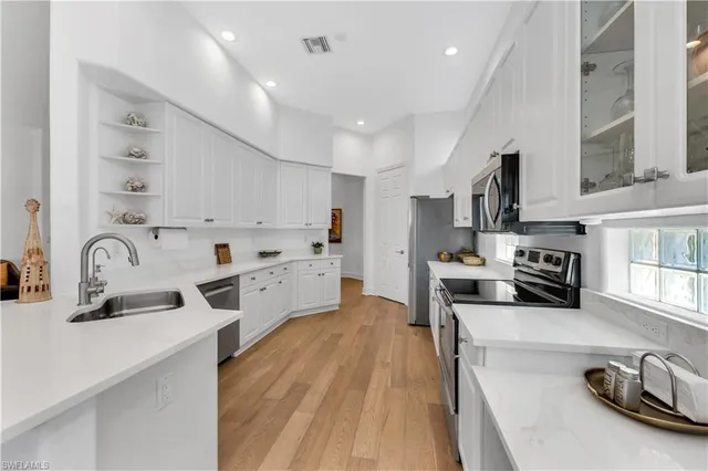 a kitchen with stainless steel appliances granite countertop a sink and cabinets