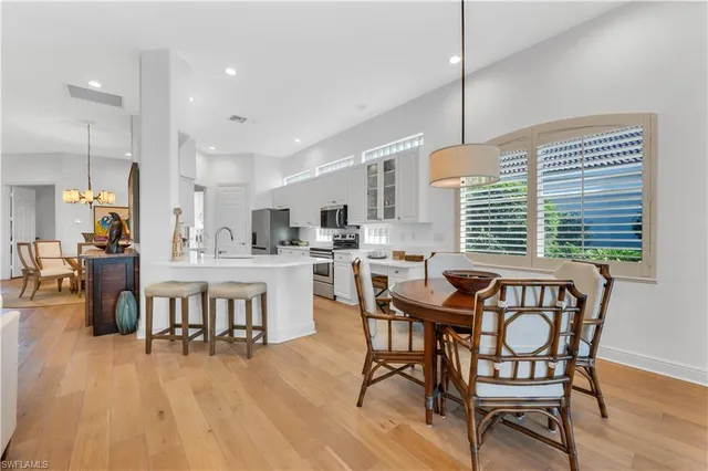 a dining room with furniture and wooden floor